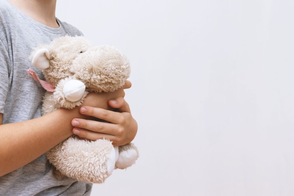 m_boy-holding-hugging-soft-toy-teddy-white-copy-space M Boy Holding Hugging Soft Toy Teddy White Copy Space 1024x682